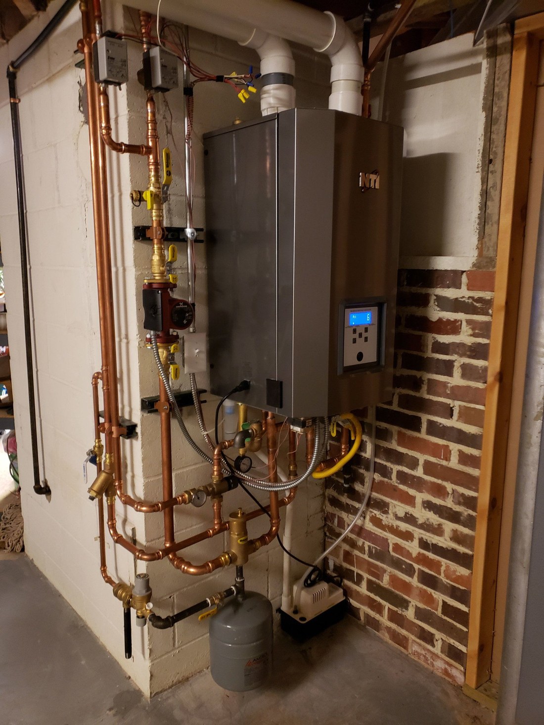 New furnace installed by the JC team in a brick basement