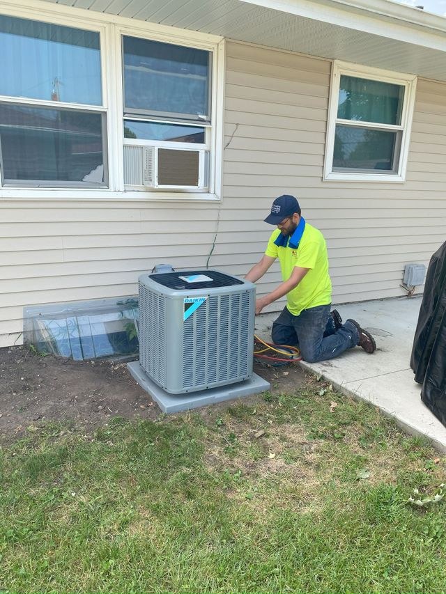 JC technician servicing an outdoor AC unit